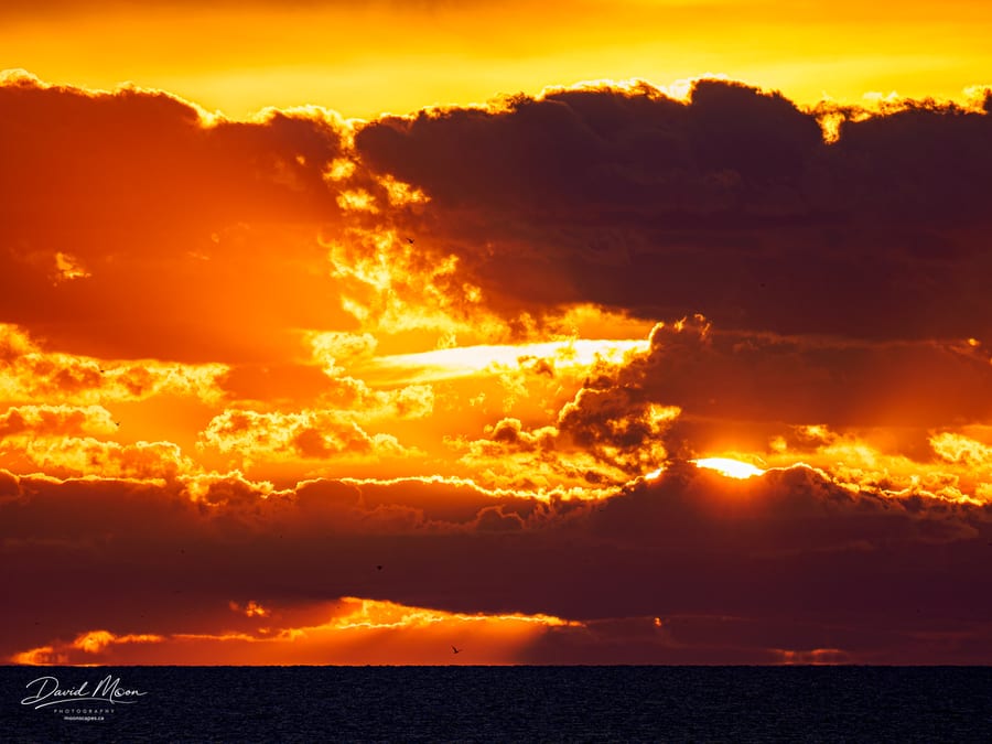 Atlantic Sunrise Through Clouds