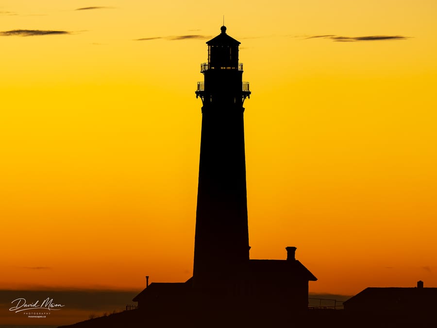 Lighthouse Against an Amber Sky