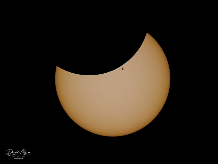 Late Partial Eclipse with Sunspot